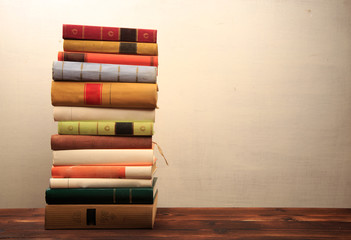 Old books on a wooden shelf.