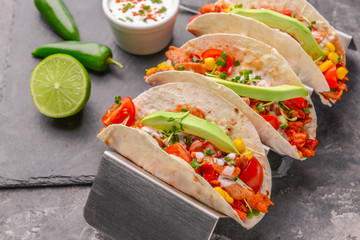 Tasty tacos on grunge background