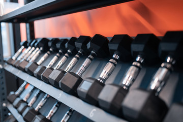 Close up of big amount of barbells lying in fitness gym