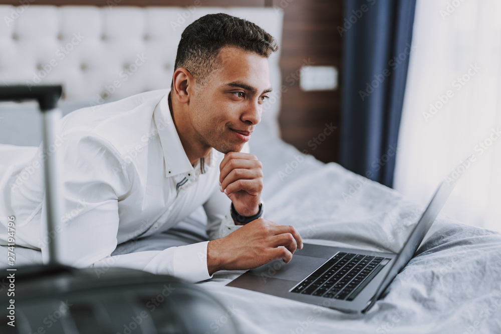 Wall mural merry businessman is working on laptop indoors