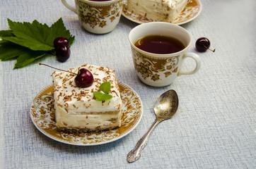 Tiramisu, a traditional Italian dessert in a light background. Close-up