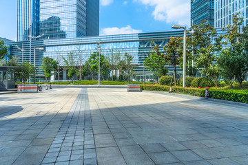 empty brick floor front of modern buildings.