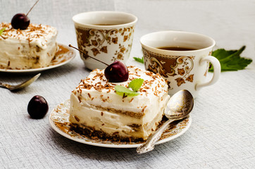 Tiramisu, a traditional Italian dessert in a light background. Close-up