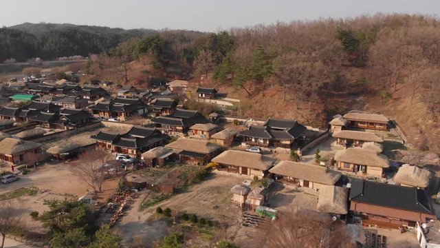 Aerial gentle rise up tilt down above Korean traditional village