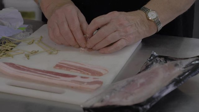 Preparation of a horderve appetiser using bacon and prunes. Referred to as a "angels on horseback" or "devils on horseback"