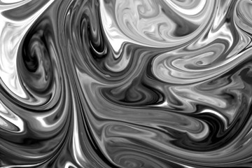 liquid paints mixed together creating black and white abstract.
