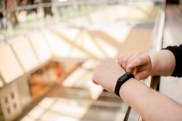 Man is wearing a fitness bracelet. Smart watch on the hand of a man. Pensioner Using Fitness Tracker.