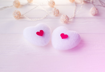 Red and white hearts on wooden background. Saint Valentine's day concept. Love and romantic photo. Postcard for holiday. Small rustic lights.