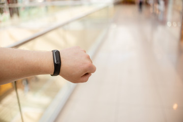 Man is wearing a fitness bracelet. Smart watch on the hand of a man. Pensioner Using Fitness Tracker.