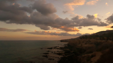 Beautiful cloudy sunset over the rocky ocean coast. Costa Calma, Fuerteventura, Canary Islands
