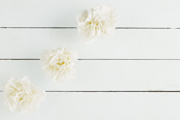 Top view flowers on wooden background