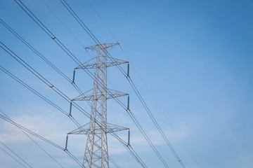 High voltage post tower with blue sky before sunset