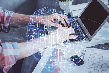 Businessman with computer background with brain theme hologram. Concept of brainstorm. Multi exposure.