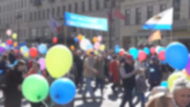 demonstration of peaceful petitioners with banners and colored balls on the streets of the city on the day of the city holiday. Blurred anonymous people on the street at rally. Super slow motion 1000 
