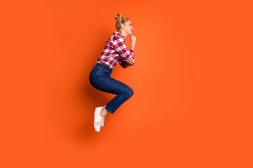 Fototapeta na wymiar Full length side profile body size photo amazing funny she her lady jumping high sporty body shape competition position wear casual jeans denim checkered plaid shirt isolated orange background
