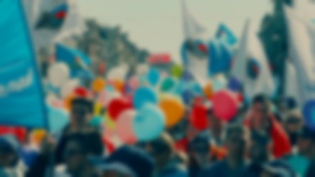demonstration of peaceful petitioners with banners and colored balls on the streets of the city on the day of the city holiday. Blurred anonymous people on the street at rally. Super slow motion 1000 