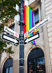 Saint Catherine street sign and a LGBT rainbow gay pride flag