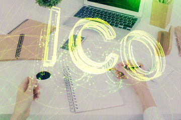 Cryptocurrency hologram over woman's hands writing background. Concept of blockchain. Multi exposure