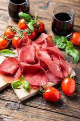 Italian antipasto with bresaola and red wine