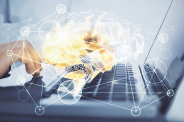 Man typing on keyboard background with brain hologram. Concept of big Data.