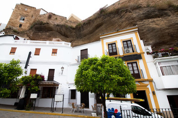 Street and small square, small street cafe under the overhanging cliffs in Setenil de las Bodegas, Spain, Andalusia