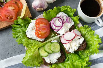 ricotta and vegetable sandwiches, tomato, cucumber, onion, radish, lettuce, Cup of black coffee, delicious Breakfast,
