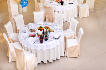 Banquet table with chairs, dishes