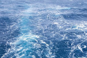 Naklejka na ściany i meble Boat Wave ocean trace on blue sea Red Sea Seashore Egypt background.