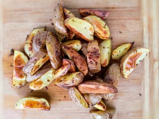 pieczone ziemniaki z kminkiem na drewianej desce