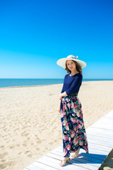 Fototapeta na wymiar Beautiful girl in a dress on the beach, fashion woman, sea, sunny island