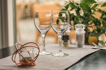 Served table set at summer terrace cafe with two glasses of wine
