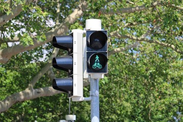green traffic light on background of blue sky