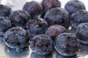 Ripe blueberries on a white background with water drops. Macro. Close-up.