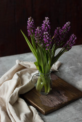 Beautiful flower bouquet on wooden table in rustic style.