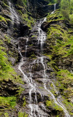 Obraz premium panorama of high picturesque waterfall in lush green forest landscape