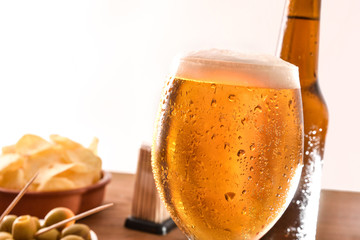Glass of cold beer with appetizer with  white background detail