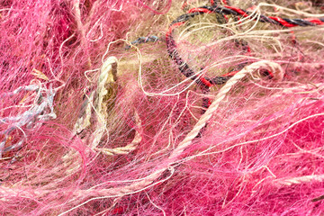 A tangled mess of fishing nets plastic rope and other debris washed up on a coastal beach. Save the Planet stock picture.