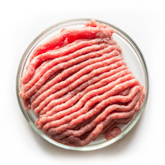 Laboratory studies of artificial meat. Minced meat in glass Petri dish. Square image. Close up. View from above. Chemical experiment.
