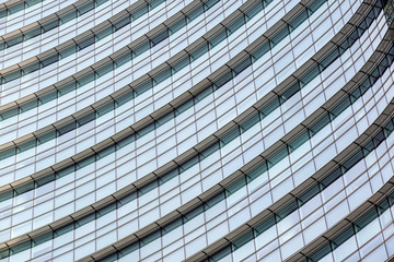 Conceptual image of textured window facade of modern design skyscraper office buildings in city business district, reflection in window surface pattern background