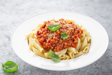 penne pasta with Bolognese sause in white plate