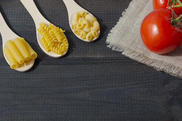 Uncooked pasta in a wooden spoon