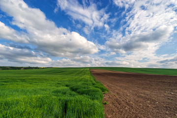 Scenic view of beautiful country landscape. Clouds passing above rural fields in South Moravia, Czech Republic.