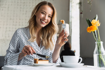 Beautiful young blonde woman sitting at the cafe