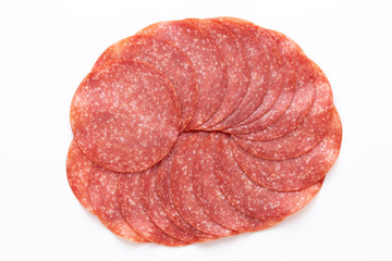 Salami slices on white background.