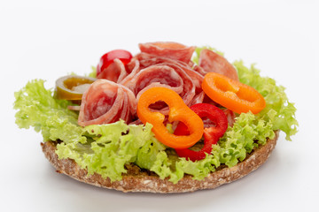 Sandwich with salami sausage on white background.