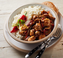 Overhead view of bowl containing meat and rice