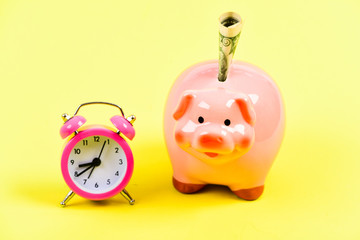it's time to get rich. retirement. family budget. business startup. financial position. piggy bank with alarm clock. Moneybox. usa dollar. Economy and budget increase. success in finance and commerce