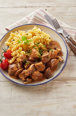 Bowl filled with delicious pasta and goulash