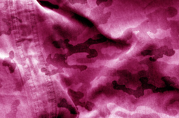 Dirty camouflage cloth with blur effect in pink tone. © pavelalexeev