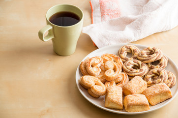 Shortbread cookies and cup with coffee on wooden table